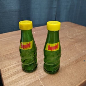 1970 Set of Green Glass Squirt Bottle Salt and Pepper Shakers with Yellow Plastic Screw-on Lids - Used Condition
