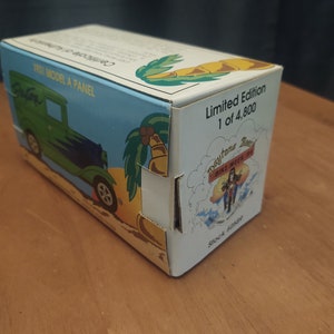 Puede incluir: Un coche de juguete azul y verde 1931 Model A Panel en una caja con una escena de playa y palmeras. La caja dice "Edici&oacute;n limitada 1 de 4.800" y "Daytona Beach Bike Week '94".
