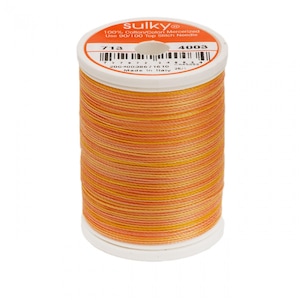 May include: A spool of Sulky 100% cotton mercerized thread in a multi-colored orange, yellow, and white pattern. The spool is labeled with the brand name Sulky, the thread number 713, and the color number 4003. The label also states that the thread is 100% cotton mercerized and that the user should use a 90/100 top stitch needle.