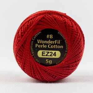 May include: A red ball of size #8 WonderFil Perle Cotton thread, made of 100% Egyptian cotton. The label reads "Double Gassed & Mercerized", "EZ24", and "5g".