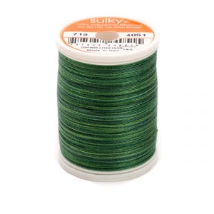 May include: A spool of Sulky 100% cotton mercerized thread in a green and dark green color combination. The spool is labeled with the number 713 and 4051. The label also states that the thread is made in Italy and is 14/0.