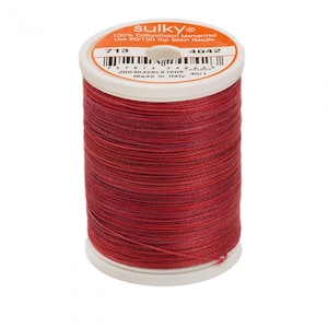 May include: A spool of red mercerized cotton thread by Sulky. The label reads "sulkyⓇ 100% Cotton/Coton Mercerized Use 90/100 Top Stitch Needle 713 4042 20040428L8 1606 Made in Italy 40/1".