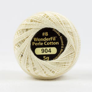 May include: A cream-colored ball of WonderFil Perle Cotton thread, size #8, with a black label. The label displays the number 904 and indicates a weight of 5g. The thread is double gassed and mercerized.