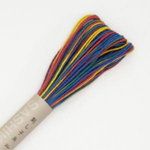 May include: A spool of colorful embroidery floss with a label that reads "Sashiko" and "20m". The floss is a mix of red, yellow, blue, and green.