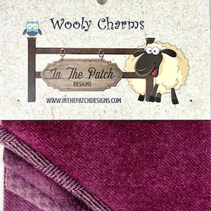 May include: A package of burgundy wool fabric with a white label that says "Wooly Charms" and "In The Patch Designs" with a cartoon sheep and owl on the label.