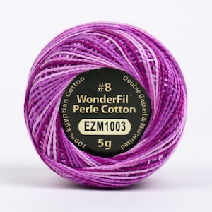 May include: A skein of purple and white WonderFil Perle Cotton embroidery thread. The label reads "#8 WonderFil Perle Cotton EZM1003 5g 100% Egyptian Cotton Double Gassed & Mercerized".