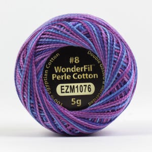 May include: A ball of purple, pink, and blue embroidery floss with a label that reads "#8 WonderFil Perle Cotton EZM1076 5g Double Gassed Mercerized 100% Egyptian Cotton"