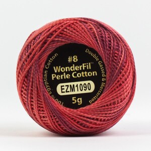 May include: A spool of red and burgundy WonderFil Perle Cotton embroidery thread. The label reads "#8 WonderFil Perle Cotton 100% Egyptian Cotton Double Gassed & Mercerized EZM1090 5g".