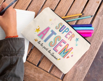 May include: A white canvas pencil case with a colorful design that says "Super Atsem" and "de la part de Louise".