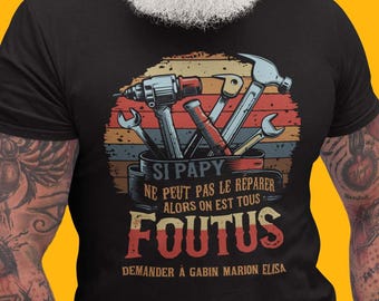 May include: A black t-shirt with a vintage-style graphic of tools in a toolbox. The text on the shirt reads "Si papy ne peut pas le reparer alors on est tous foutus demander à gabin marion elisa".