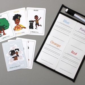 May include: A set of color recognition cards with illustrations and text. The cards feature colors like green, yellow, black, white, blue, purple, orange, and red. There is also a dry-erase board with sections for each color.