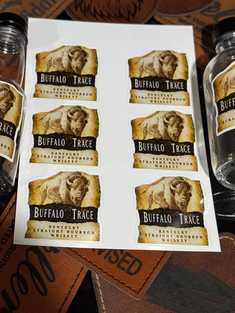 May include: Six Buffalo Trace Kentucky Straight Bourbon Whiskey labels with a brown buffalo illustration on a white background. The labels have a gold scroll design and the text "Buffalo Trace Kentucky Straight Bourbon Whiskey".