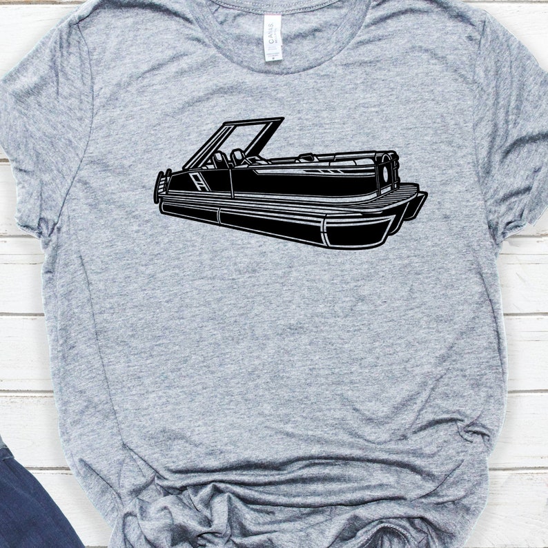 May include: A black and white illustration of a pontoon boat on a gray t-shirt.