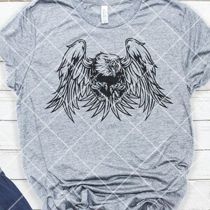 May include: A black and white graphic design of an eagle with its wings spread wide. The eagle is in a fierce pose with its talons extended.