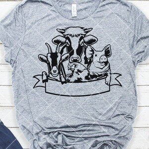 May include: A gray t-shirt with a black and white graphic of a cow, pig, goat, and chicken. The animals are all looking at the viewer and have a banner below them.