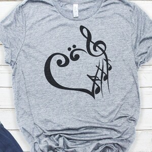 May include: A gray t-shirt with a black design of a heart made of musical notes.