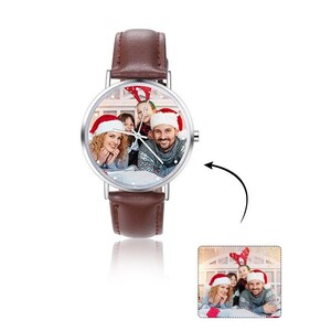 May include: A brown leather wristwatch with a silver face. The face of the watch has a photo of a family wearing Santa hats.