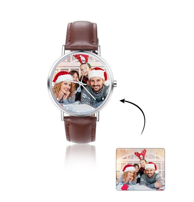 May include: A brown leather wristwatch with a silver face. The face of the watch has a photo of a family wearing Santa hats.