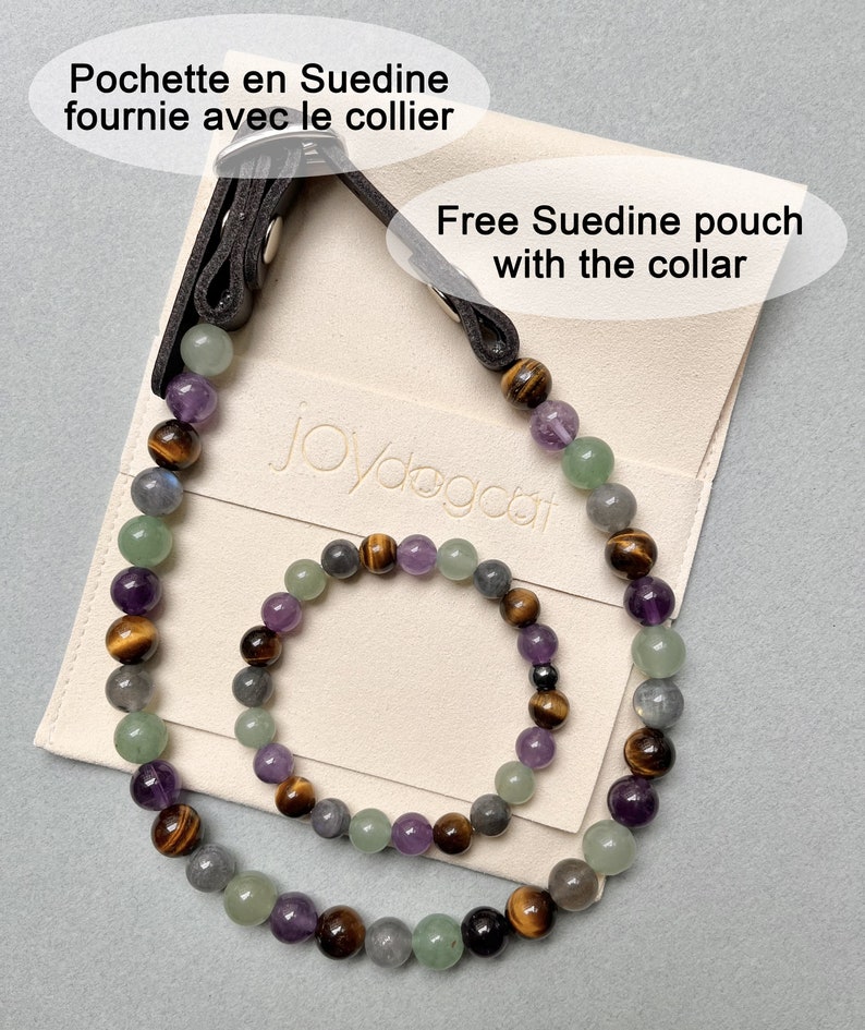 May include: A set of two beaded necklaces, one larger and one smaller, made with amethyst, tiger's eye, green aventurine, and labradorite stones. The necklaces are displayed on a cream-colored pouch with the text "Joydogcat" and the phrase "Free Suedine pouch with the collar".