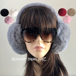 May include: Grey faux fur earmuffs with black and brown leopard print sunglasses on a mannequin head. The earmuffs are soft and fluffy.  BRIGHT IDEAS NYC is written in white at the bottom of the image.