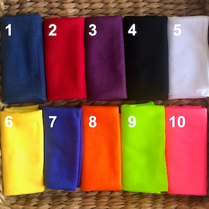May include: Ten fabric swatches in different colors, numbered 1 through 10. The swatches are arranged in two rows of five. The colors are: navy blue, red, purple, black, white, yellow, blue, orange, green, and pink.