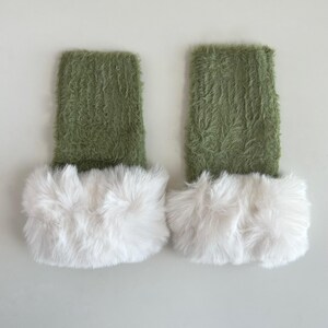 May include: A pair of green fuzzy leg warmers with white faux fur trim.
