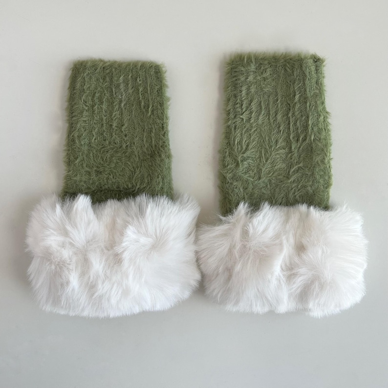 May include: A pair of green fuzzy leg warmers with white faux fur trim.