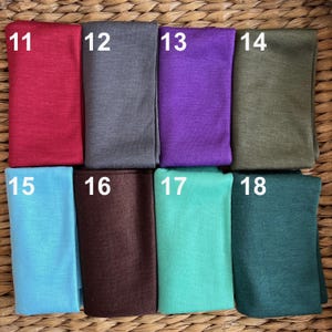 May include: Eight fabric swatches in different colors and textures. The swatches are numbered 11 through 18.