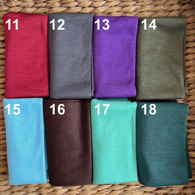 May include: Eight fabric swatches in different colors and textures. The swatches are numbered 11 through 18.