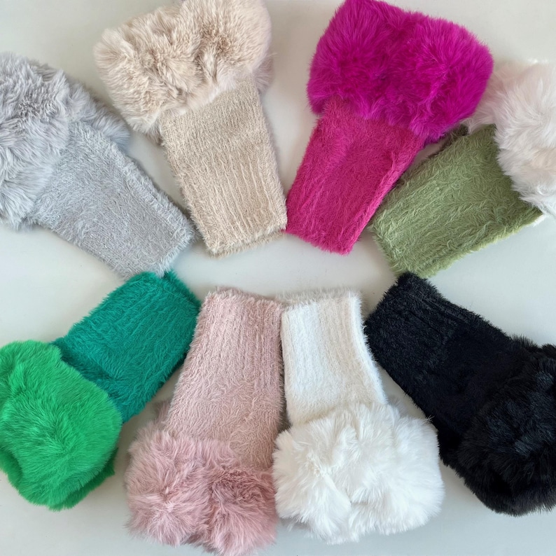 May include: Ten pairs of fuzzy knit wrist warmers with faux fur trim. The colors are gray, beige, pink, white, black, green, light green, and fuchsia.