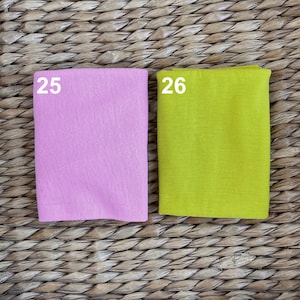 May include: Two fabric swatches, one pink and one yellow, labeled with the numbers 25 and 26.