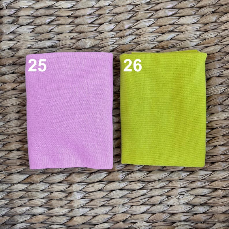 May include: Two fabric swatches, one pink and one yellow, labeled with the numbers 25 and 26.