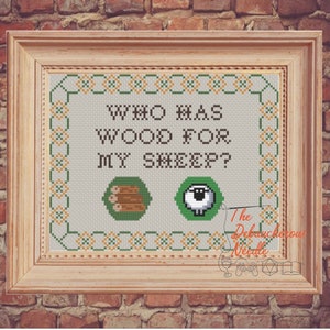 May include: Cross stitch pattern with a green background and the text "Who has wood for my sheep?" with a green and brown image of logs and a green image of a sheep's eye.