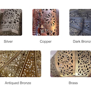May include: Five different metal lanterns with intricate cut-out designs. The lanterns are in silver, copper, dark bronze, antiqued bronze, and brass.