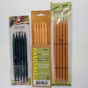 May include: A set of five 8.0 mm double-pointed knitting needles in a clear plastic package. The needles are made of sustainably harvested birch and have a 5-year guarantee. The package is labeled "Brittany" and "Knitters Pride".