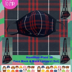 May include: Red and black plaid face mask with a matching lanyard. The mask has a black elastic band and the lanyard has a black clip. The text "Hamilton-Plaid 36 Face Mask & Mask Lanyard (Set)" is printed below the mask.