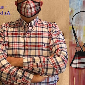 Op de afbeelding: Een rood, wit en zwart geruit mondkapje met een zwart koord. Het mondkapje hangt om de nek van de persoon die het draagt. De tekst "Linus - Plaid 2A" is zichtbaar in de afbeelding.