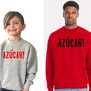 May include: Two people wearing grey and red sweatshirts with the word "AZ&Uacute;CAR!" printed in red and black on the front.