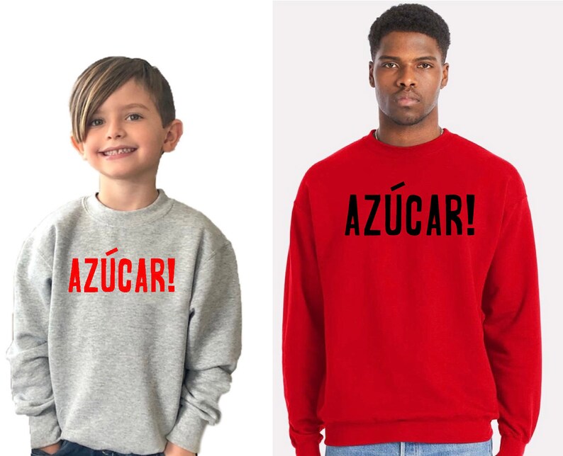 May include: Two people wearing grey and red sweatshirts with the word "AZ&Uacute;CAR!" printed in red and black on the front.