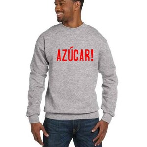May include: A gray sweatshirt with the word "AZ&Uacute;CAR!" printed in red on the front.