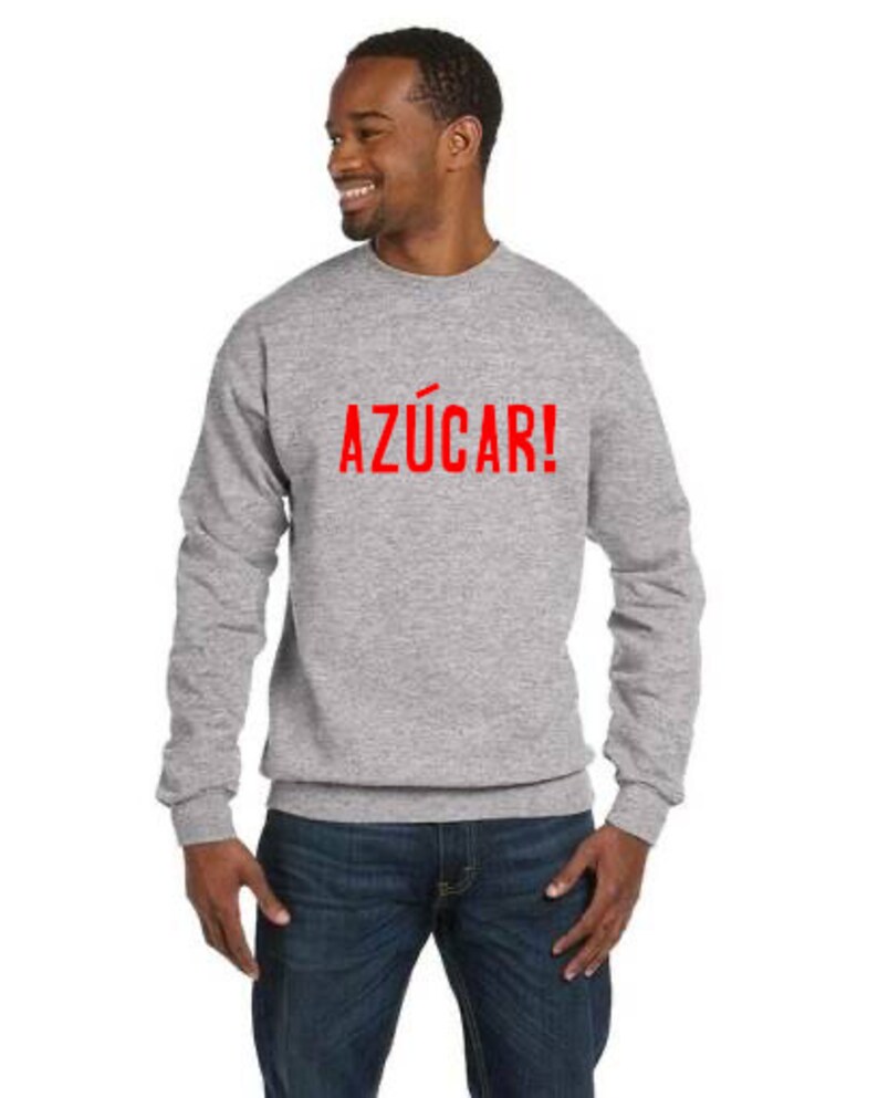 May include: A gray sweatshirt with the word "AZ&Uacute;CAR!" printed in red on the front.
