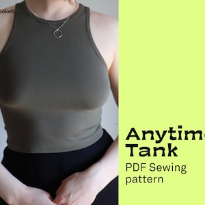 May include: A green tank top with a high neckline and a simple design. The text "Anytime Tank PDF Sewing pattern" is on a light green background.