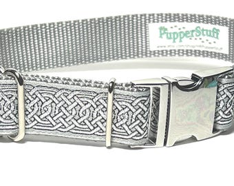 May include: A silver dog collar with a Celtic knot design. The collar has a metal buckle and D-ring. The brand name "PupperStuff" is visible on the collar.