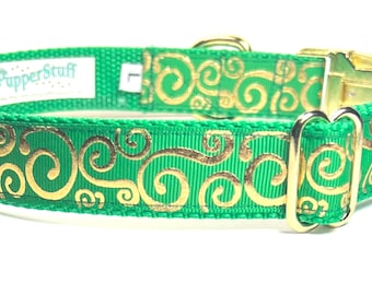 May include: Green dog collar with gold-colored scrollwork design. The collar has gold-colored metal hardware and a white tag that reads "PupperStuff" and "L".