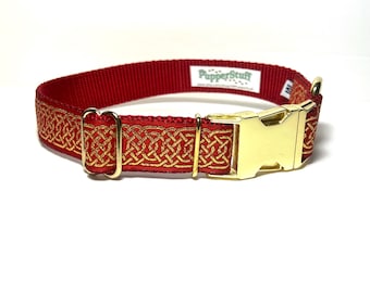 May include: Red dog collar with a gold Celtic knot design and a gold-colored buckle. The collar has the text "PupperStuff" printed on it. The collar is made of a durable material.