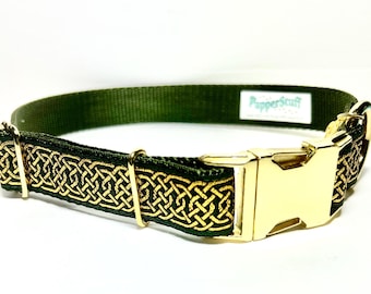 May include: A green dog collar with a gold Celtic knot design. The collar has a gold-colored metal buckle and hardware. The brand name "PupperStuff" is visible on a white tag.
