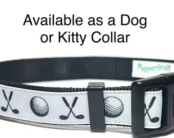 May include: Black and white dog or kitty collar with a golf theme. The white band features golf balls and crossed golf clubs. The collar has a black buckle and a metal D-ring.
