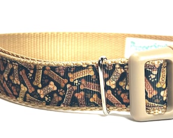 May include: Tan dog collar with a repeating pattern of bones and paw prints in brown and tan. The collar has a beige plastic buckle and a metal D-ring for leash attachment.
