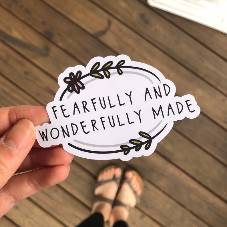 May include: White oval sticker with a floral border and the text "Fearfully and Wonderfully Made".