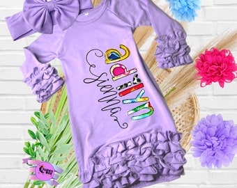 May include: Purple baby gown with a colorful "My girl" graphic and ruffles around the sleeves and bottom. The gown comes with a matching purple headband.